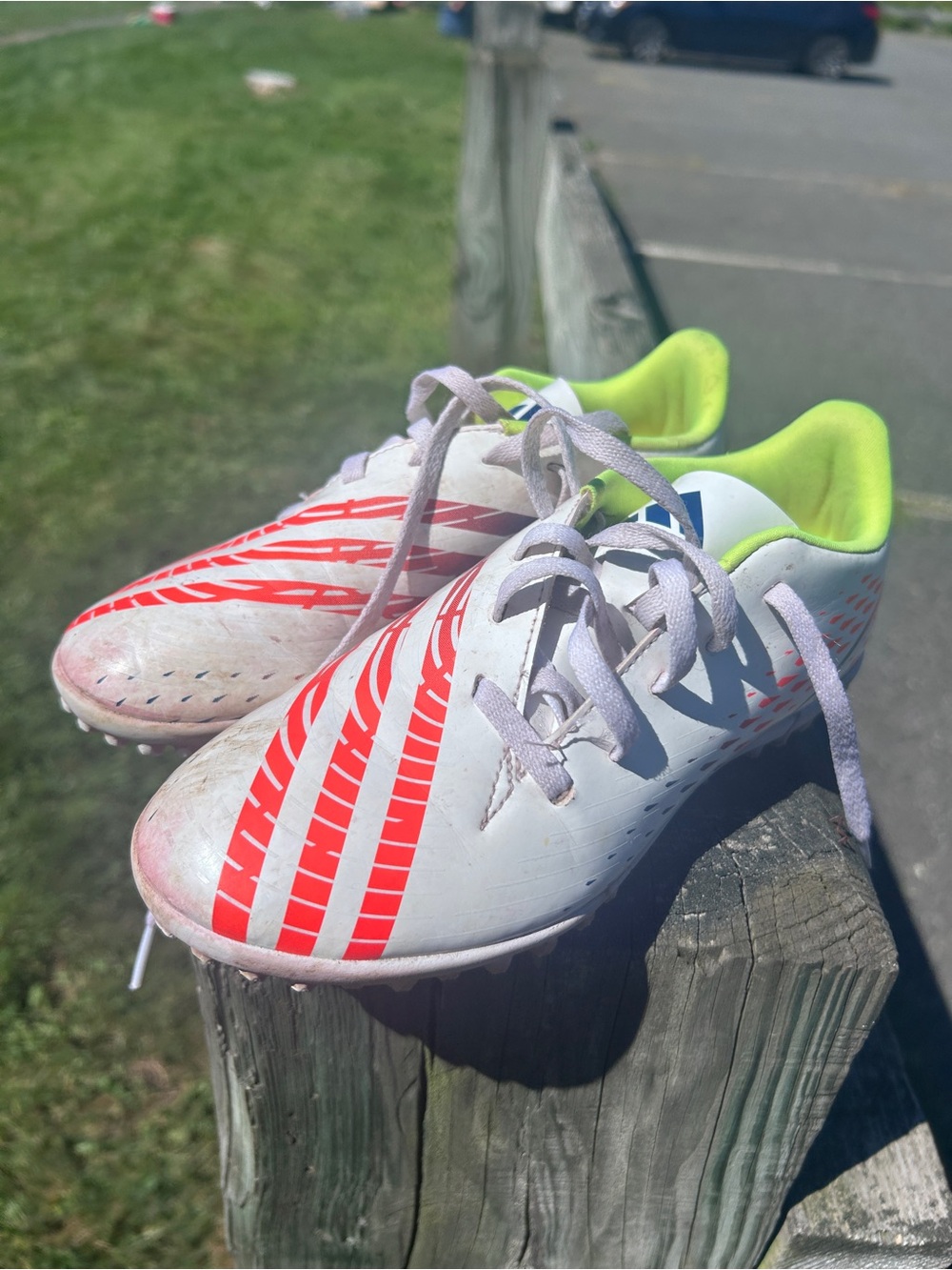 Adidas Kids White Soccer Cleats with Red Stripes and Neon Green Lining
